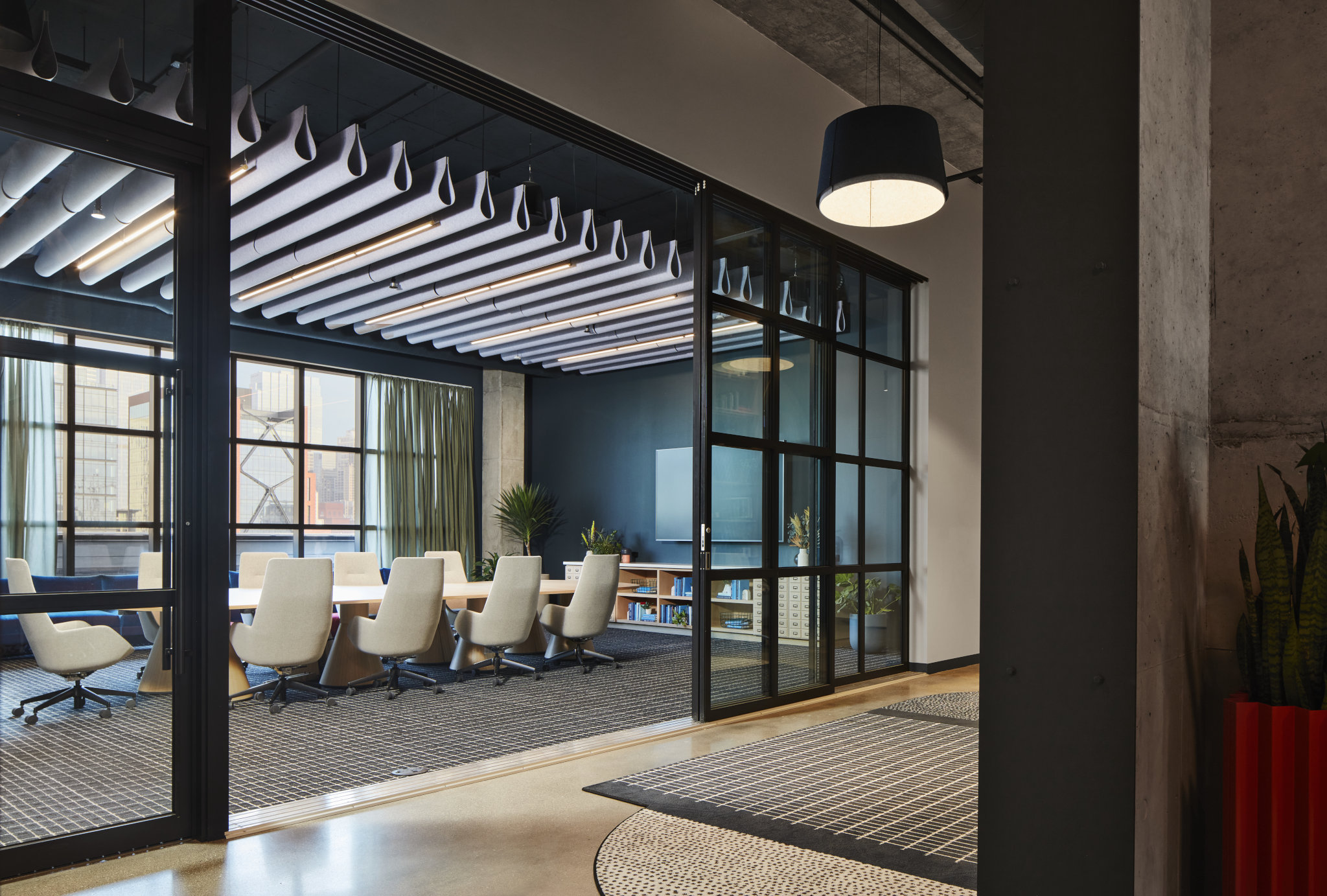 Office space featuring soaring arched windows and metal accents